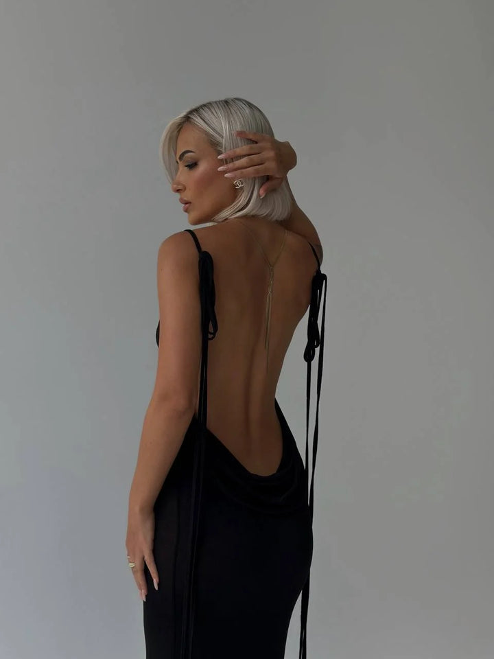 Alt text: "Karmen backless dress with adjustable ties, showcasing a sleek and modern design for effortless chic style."