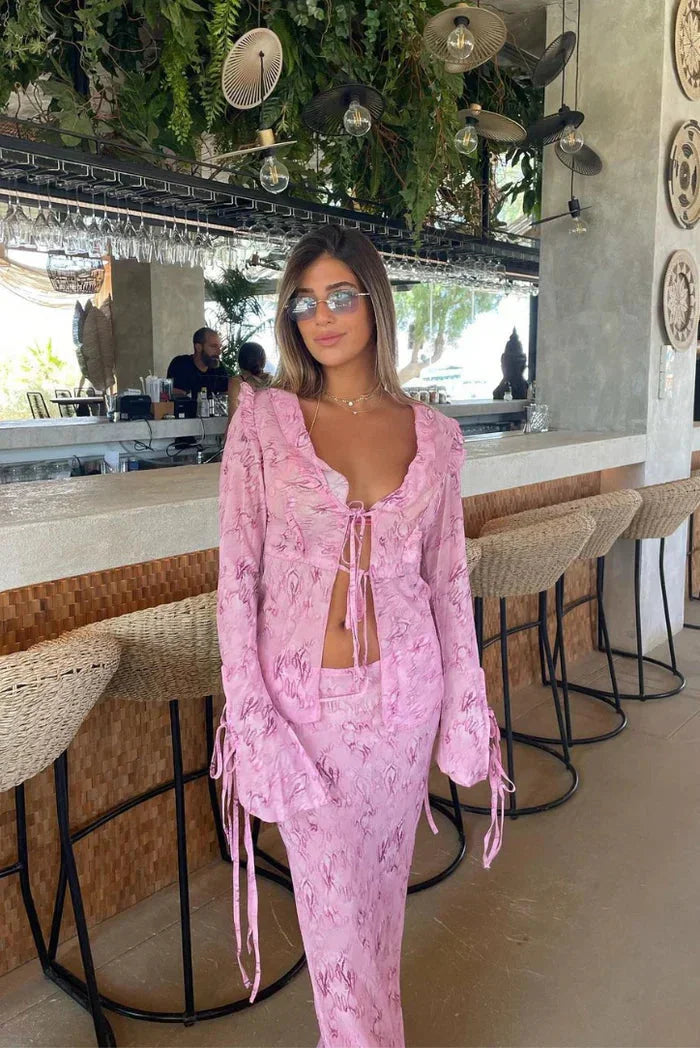 "Maha two-piece set featuring a ruffled pink blouse and flowy maxi skirt in soft, lightweight fabric."