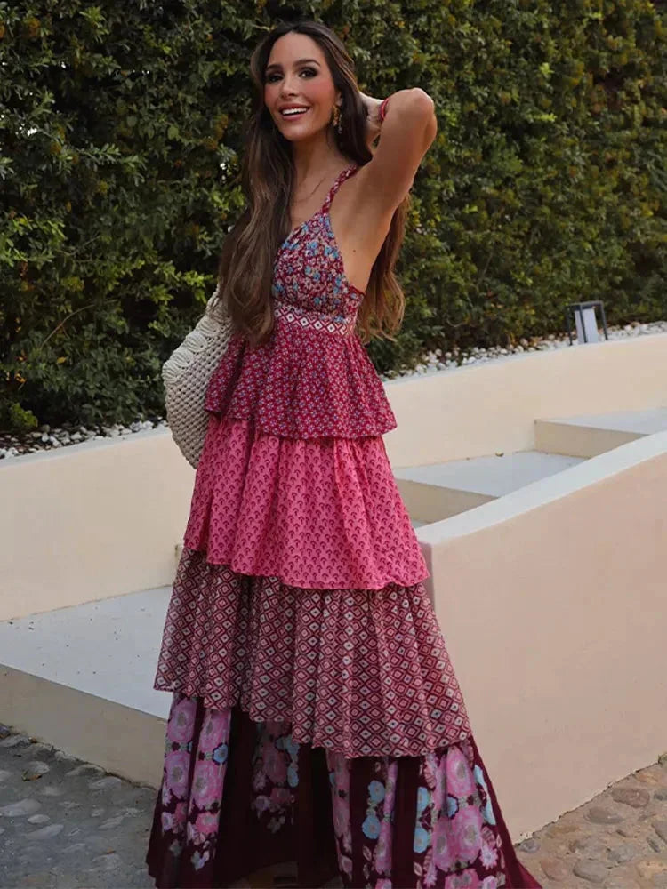 "Sleeveless red and pink multi-tier dress in a vibrant color combination with a flowing design, perfect for any casual…