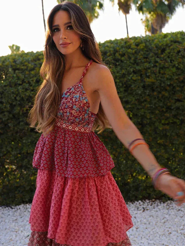 Sleeveless red pink dress with multi-tier design in lightweight fabric.