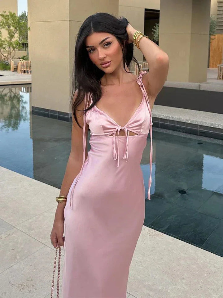 Soft pink satin maxi dress with adjustable straps, perfect for special occasions, elegant and comfortable design.