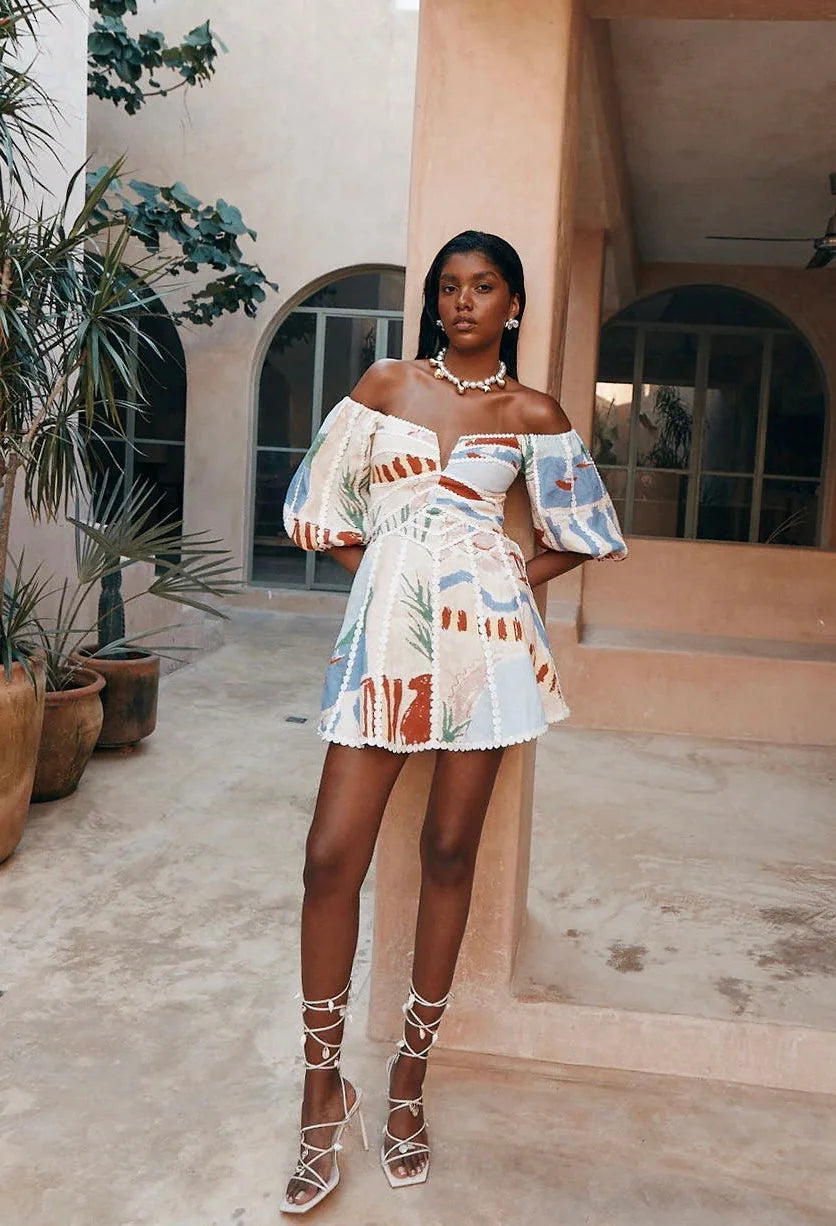 White patterned off-shoulder dress for women by Awa showcasing a stylish design with a summer-ready silhouette and soft…
