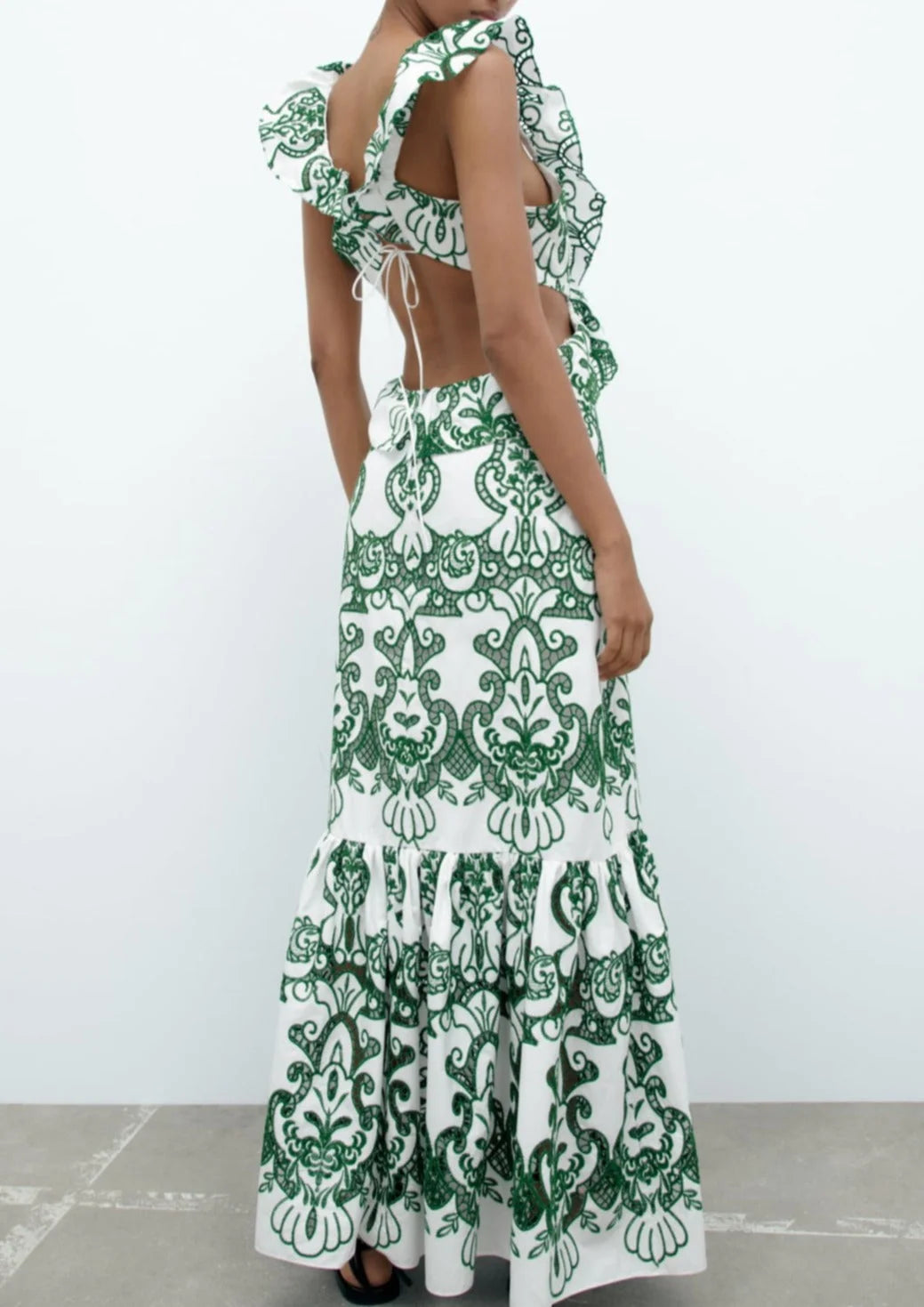"White and green ruffled maxi dress made of soft flowing fabric, perfect for a breezy summer day"