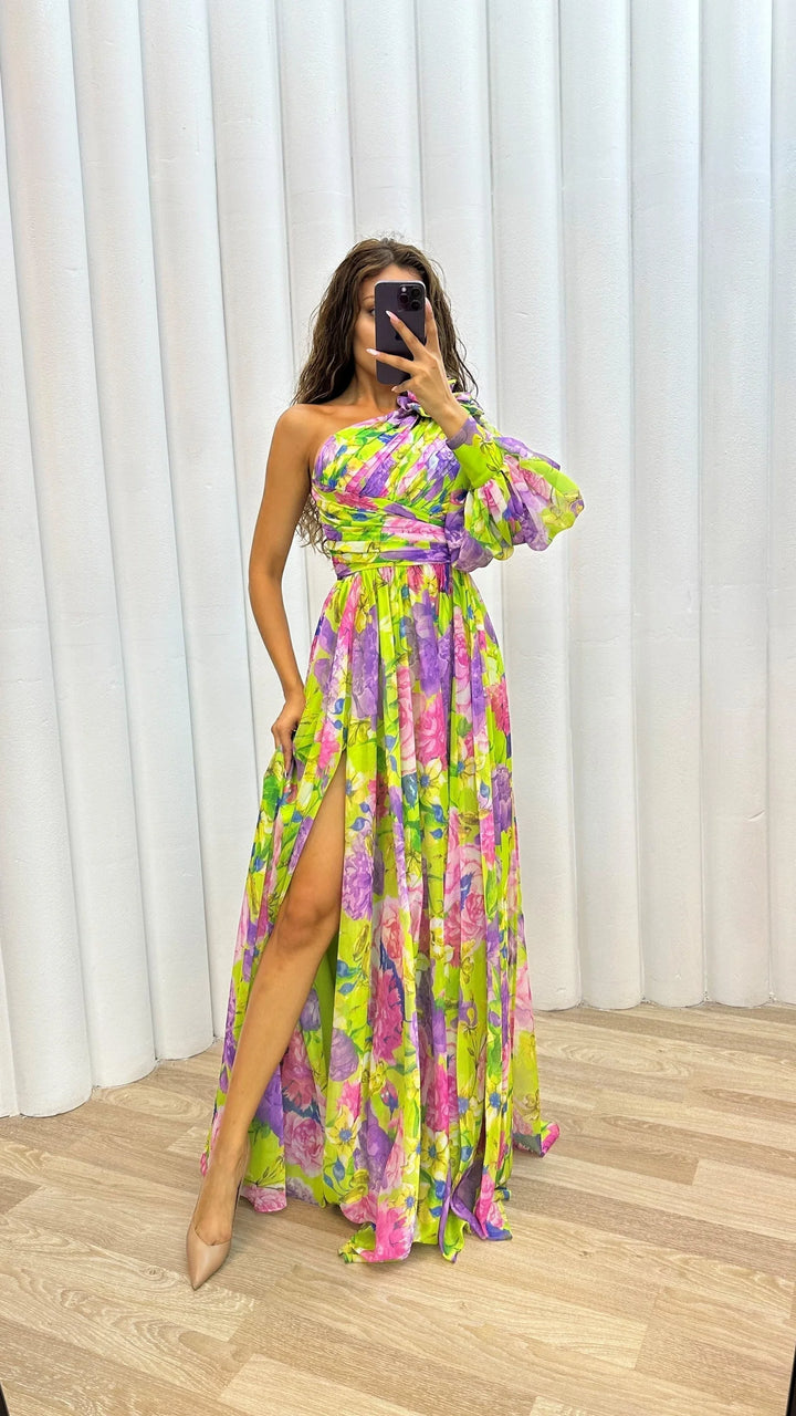 Yellow one-shoulder floral dress by Story, featuring a flowing design, perfect for adding a touch of elegance to any…