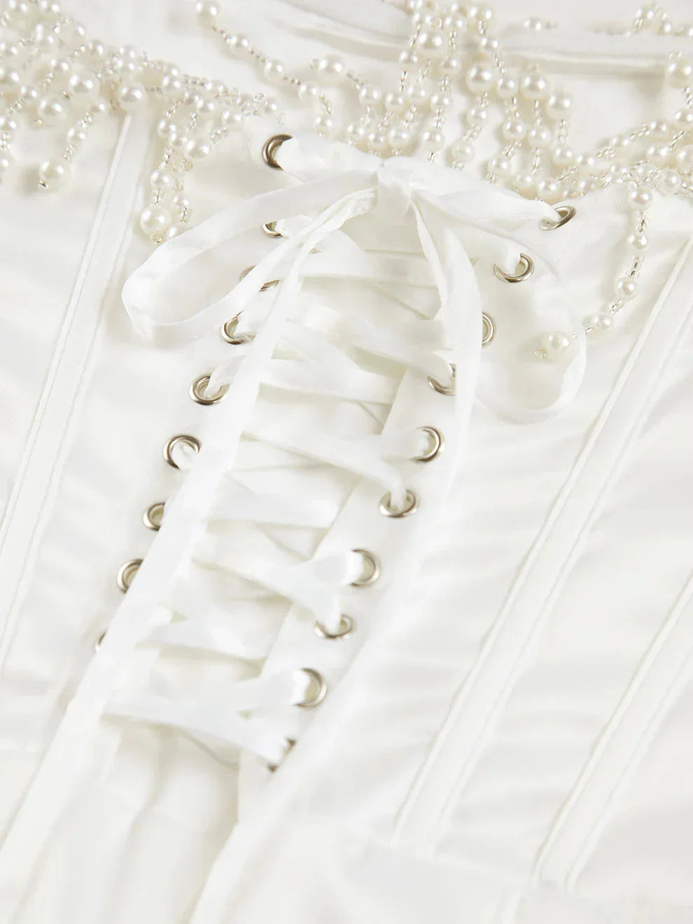 "Ivory strapless midi dress with intricate bead detailing, perfect for elegant occasions"