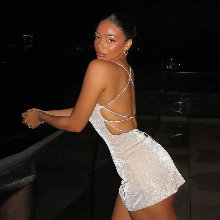 Black mini dress with sparkly sequins, featuring an alluring open back design by Kaylanni.