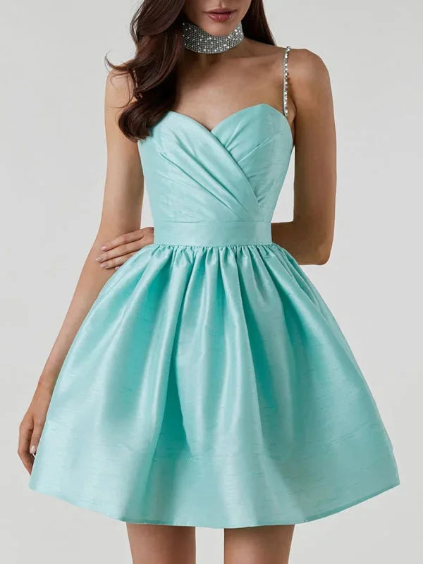 Blue satin mini dress with rhinestone straps by Carrington, a dazzling choice for your next event.