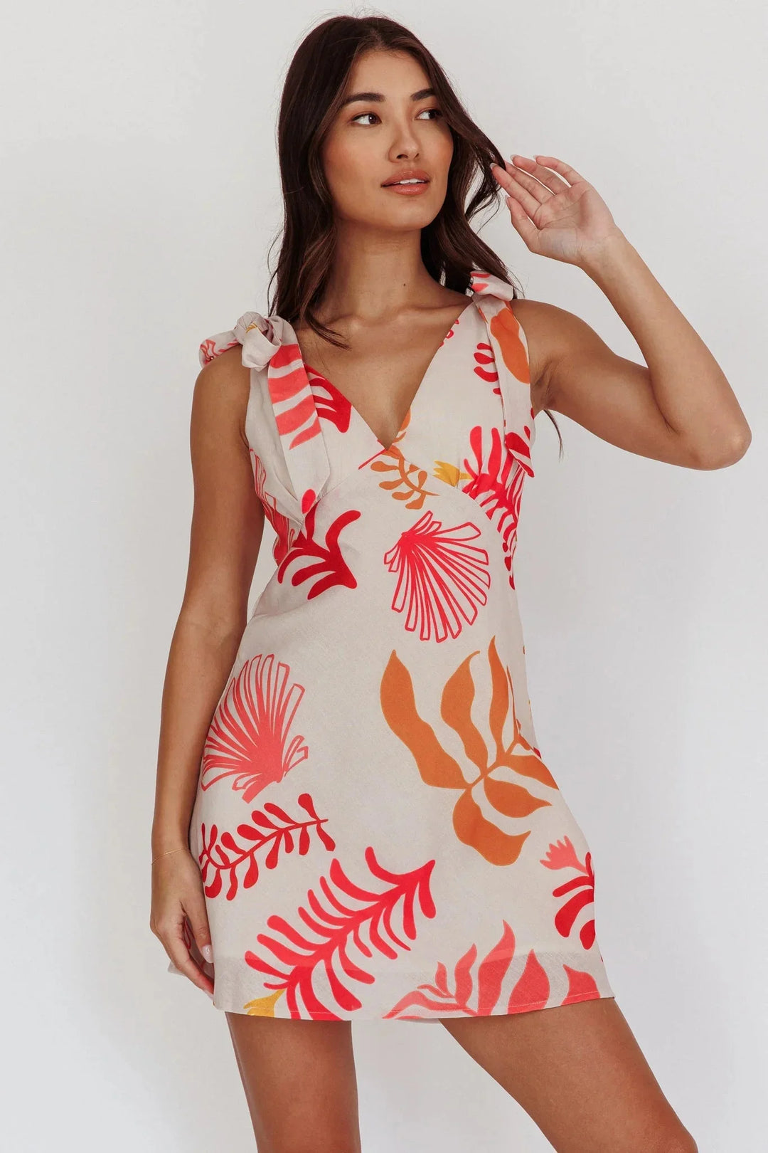 Red floral print V-neck mini dress by Novaleigh. Features a lightweight and breathable fabric perfect for summer days.