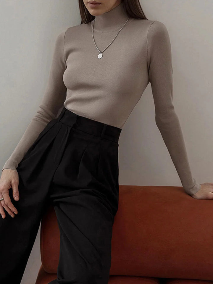 Kori seamless turtleneck in gray, ribbed knit fabric, high-neck design, perfect for layering or stand-alone outfit.