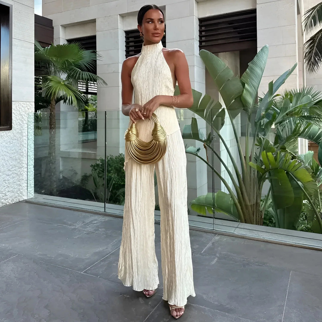 White pleated halter top jumpsuit with a unique and stylish design, perfect for adding an elegant touch to your wardrobe.