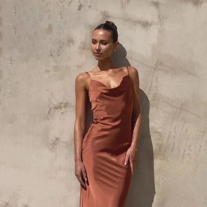 Sleeveless maxi dress in navy blue with cowl neckline, perfect for summer events or weekend outings.