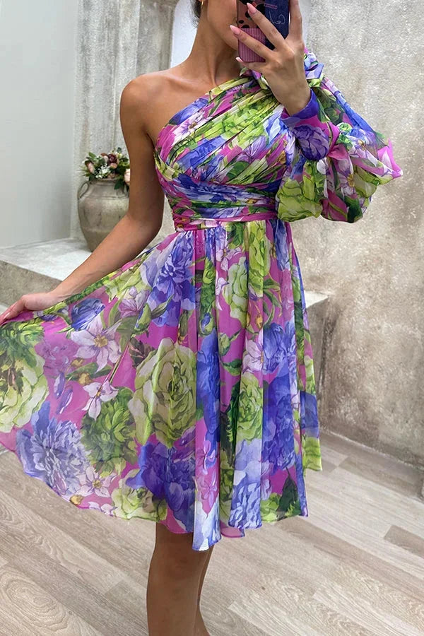 "Elia - Asymmetrical floral dress with single sleeve, featuring a light and airy fabric perfect for summer outings."