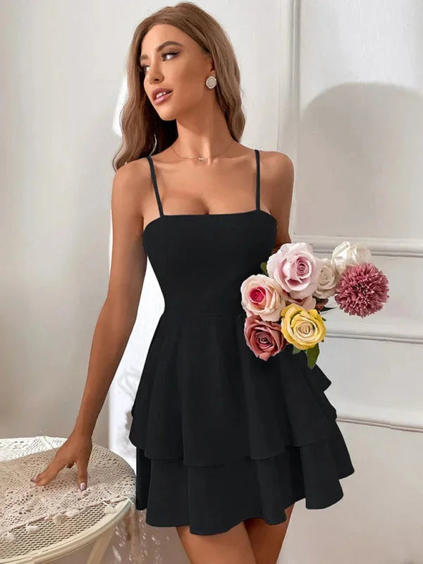 "Arwyn Mini Dress: Tiered design with adjustable straps, made of lightweight breathable fabric."