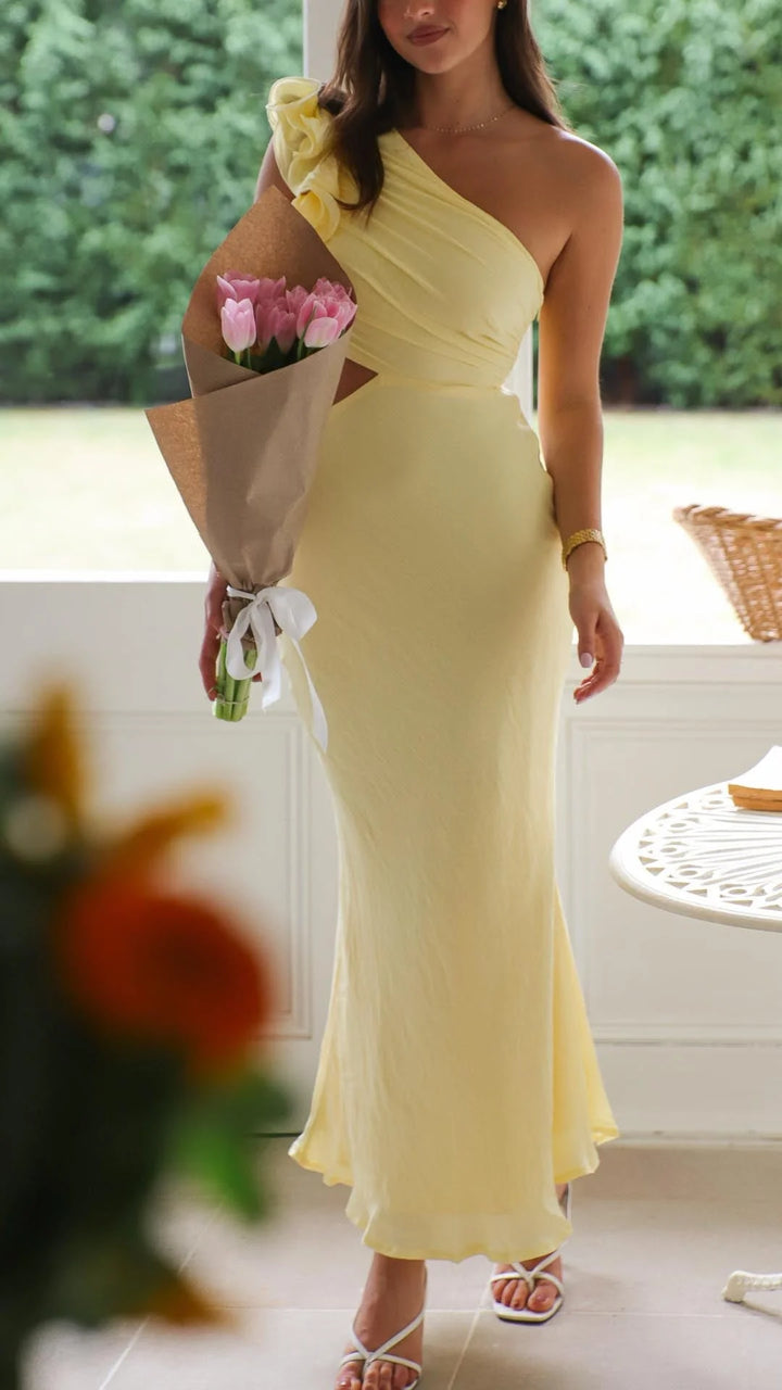 Yellow one-shoulder maxi dress with cutouts, perfect for a summer day out. Made from lightweight and breathable fabric.
