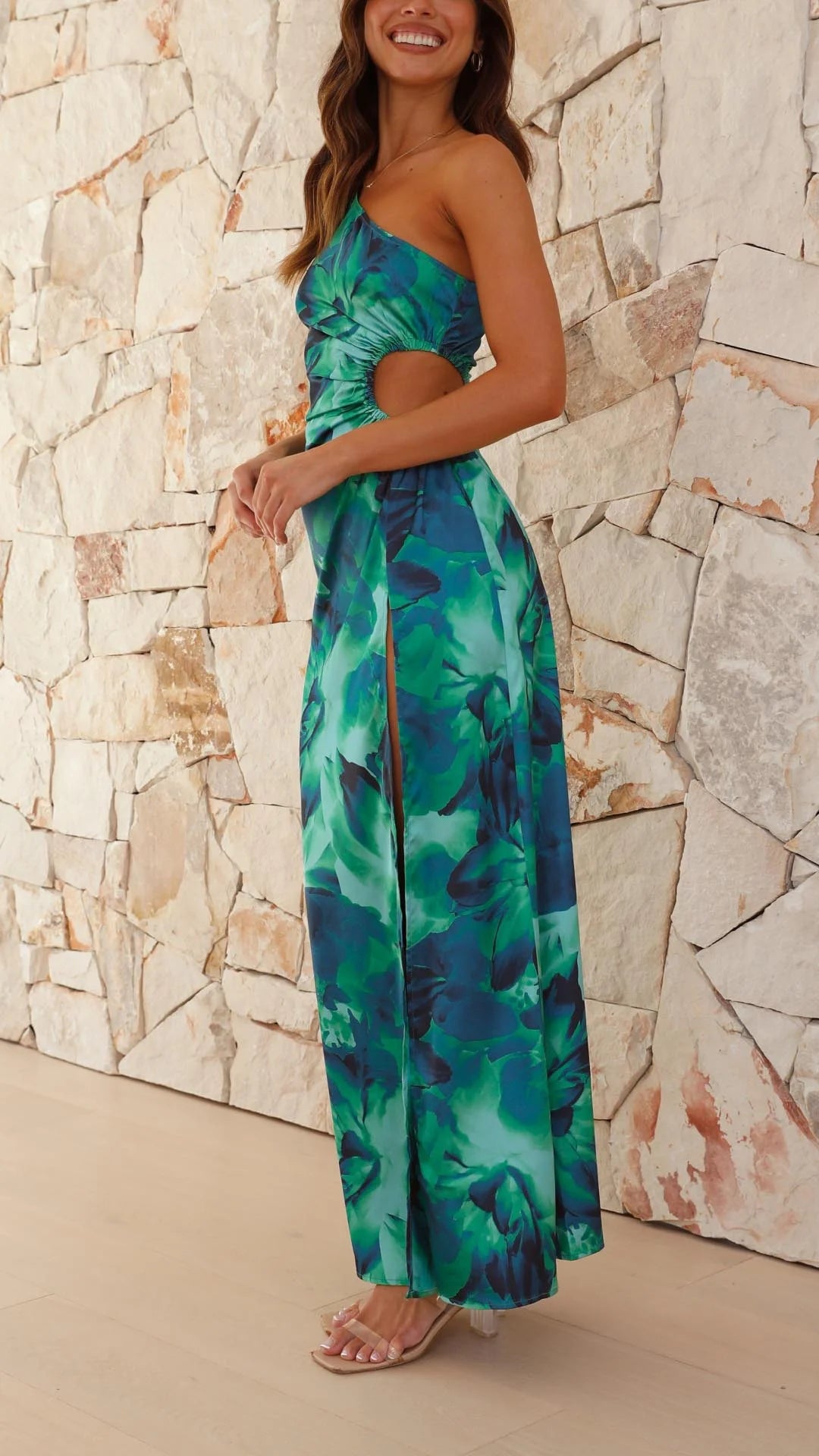 Green floral maxi dress with one-shoulder design, a flowy silhouette in light and breathable fabric perfect for summer…
