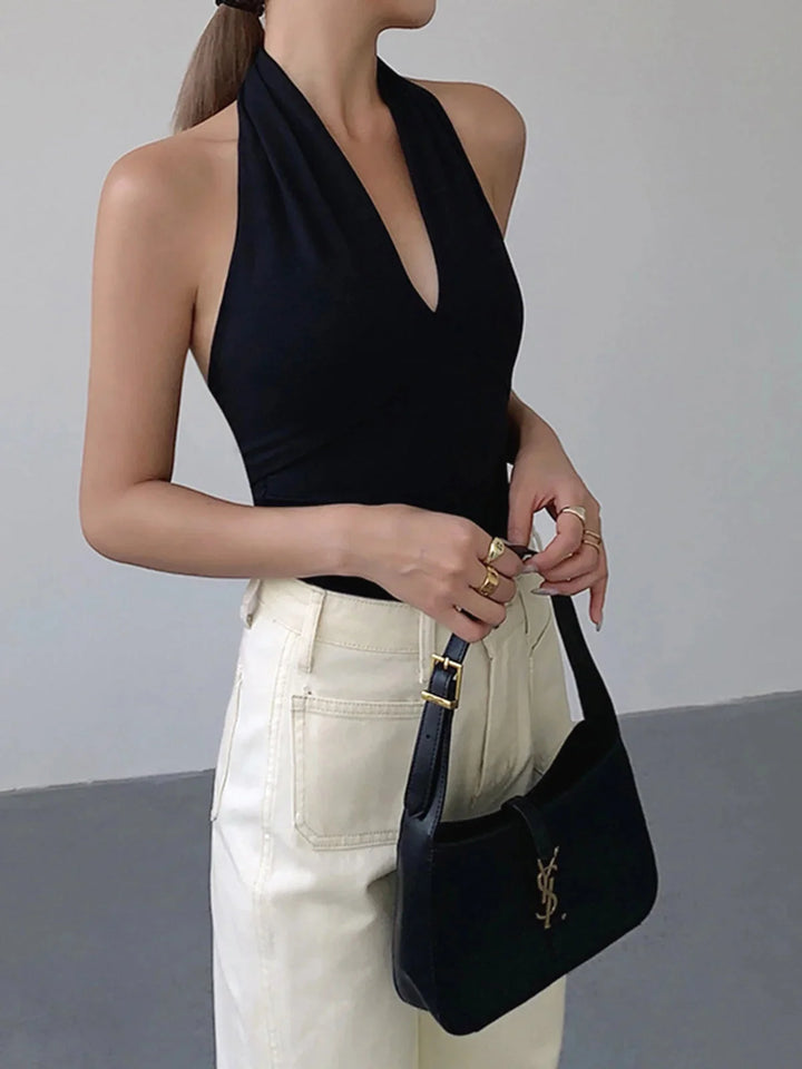 Black halter crossover top made of satin with a sleek design, suitable for casual or formal wear.