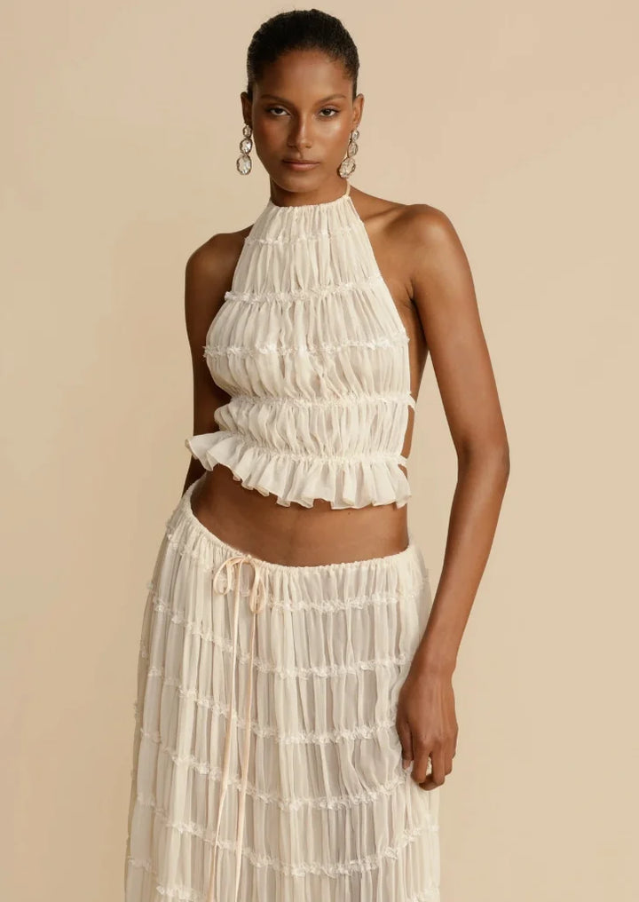 "Women's two piece ruffled ivory skirt set with intricate lace detailing for a chic and feminine look"