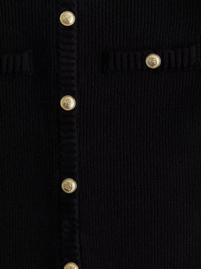 Short sleeve black ribbed mini dress with a flattering silhouette, ideal for casual or formal occasions.