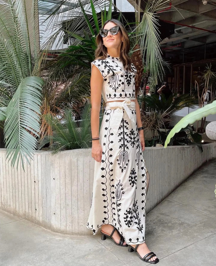 "White sleeveless top and skirt set with intricate embroidery details, perfect for a stylish and elegant look."