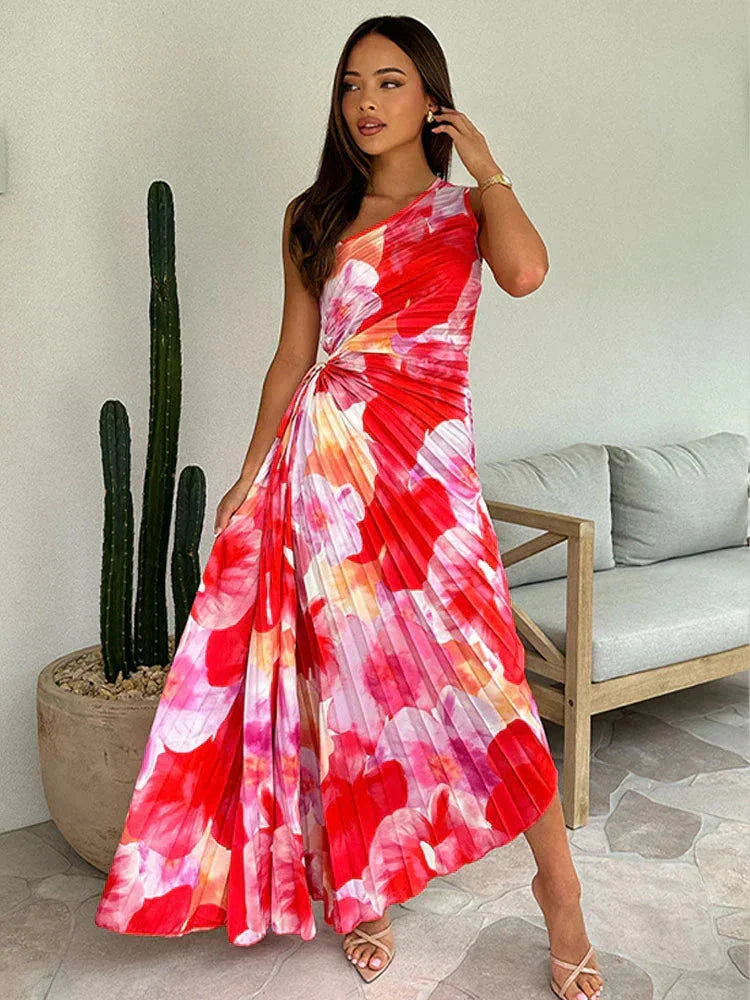"Floral maxi dress in soft fabric with an asymmetric neckline featuring a botanical print and a flowing silhouette."