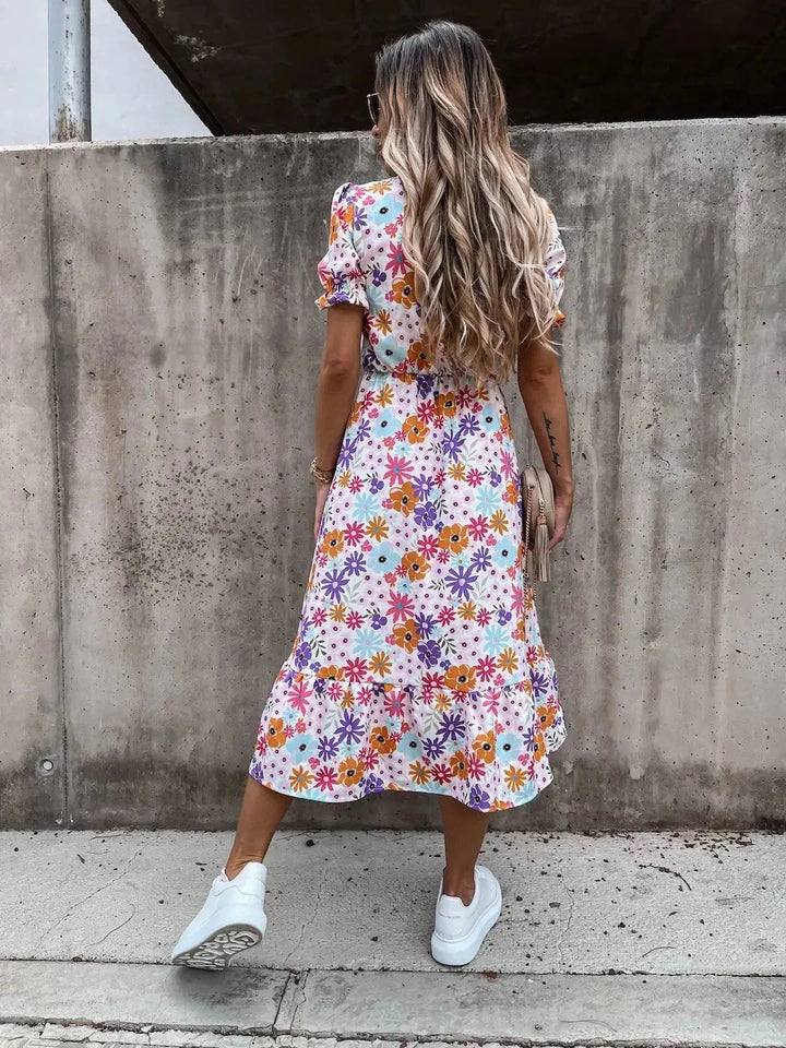 Floral-print midi dress with wrap front detail, featuring vibrant colors and elegant design by Kasandra.