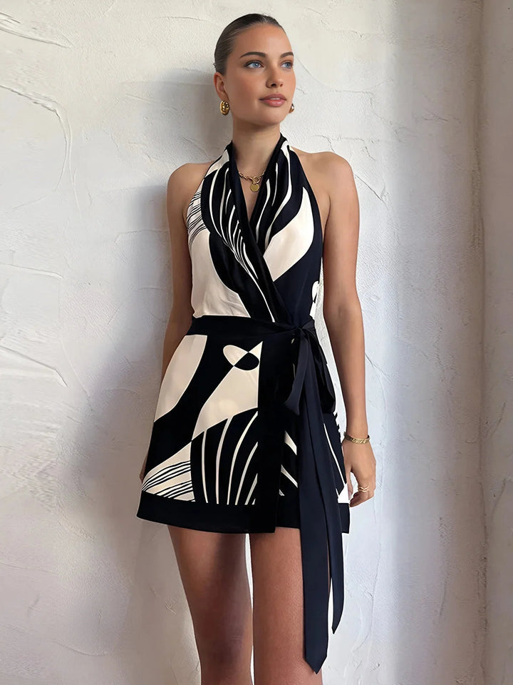 "Sleeveless black and white wrap dress with modern monochrome design, perfect for effortless chic style."