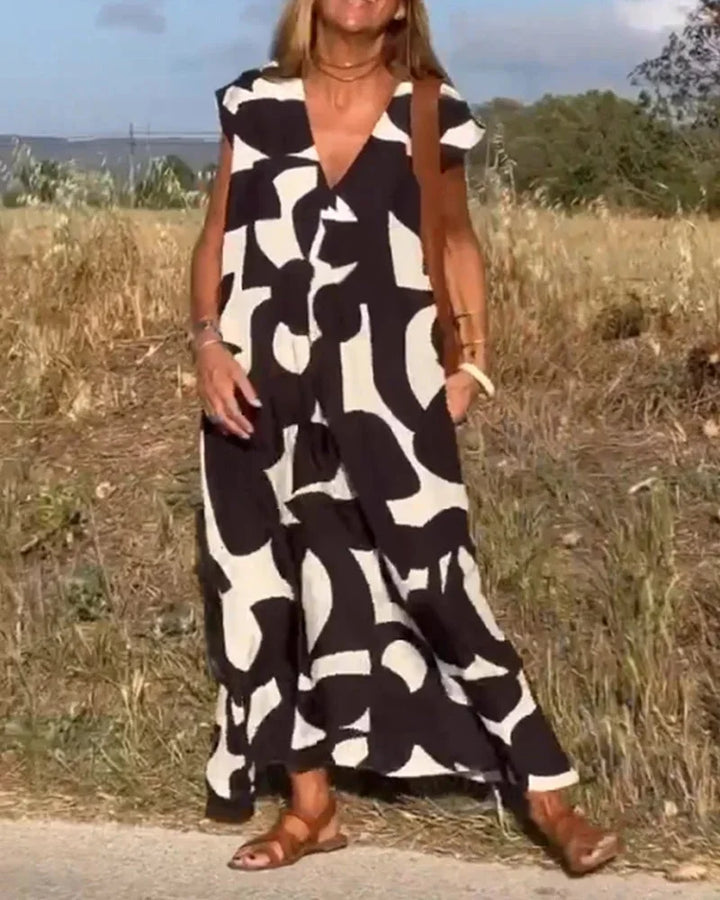 "Arisbeth maxi dress featuring a flowy V-neck silhouette with bold patterns perfect for casual, everyday wear."