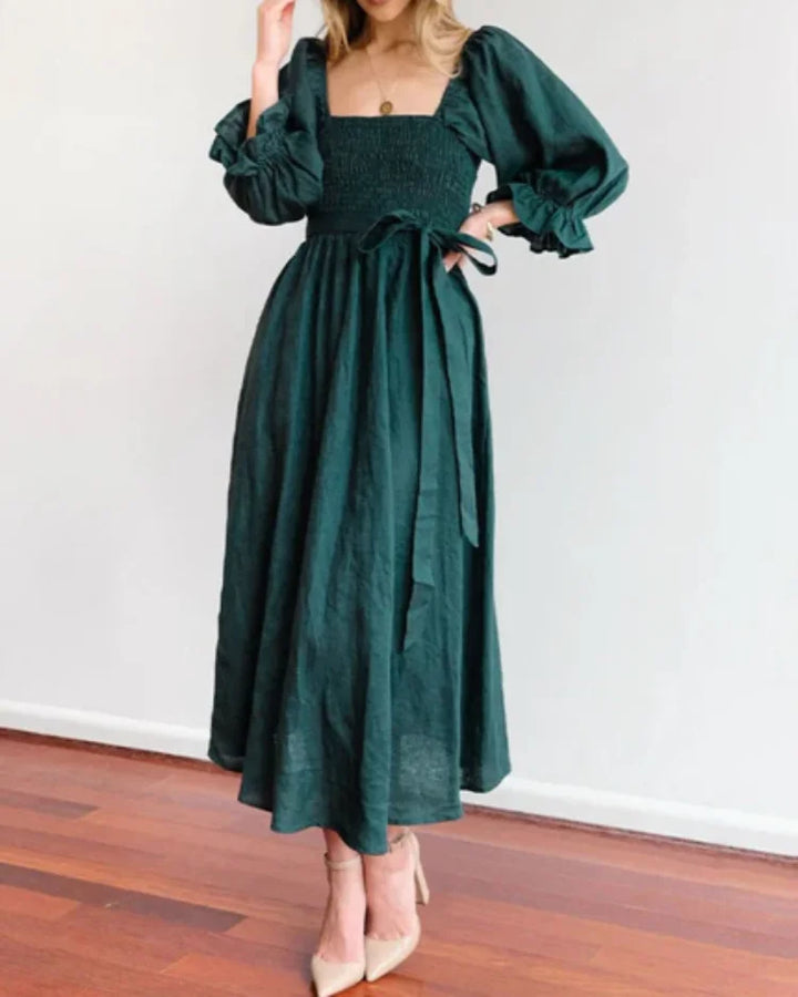 "Black wrap dress with deep V-neckline made of flowy fabric, perfect for a night out."