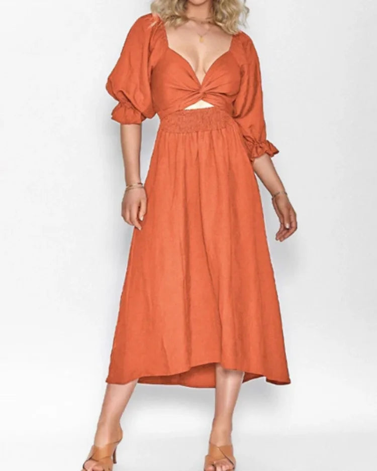 Orange wrap dress with deep V-neckline by Jessi. Flowy and comfortable jersey fabric perfect for casual or special…