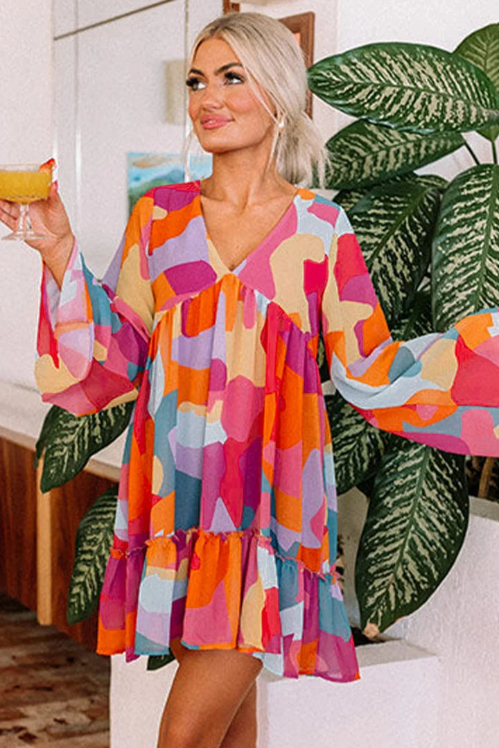 "Vibrant printed V-neck babydoll dress by Karson, featuring a flowy silhouette and colorful pattern, perfect for summer…