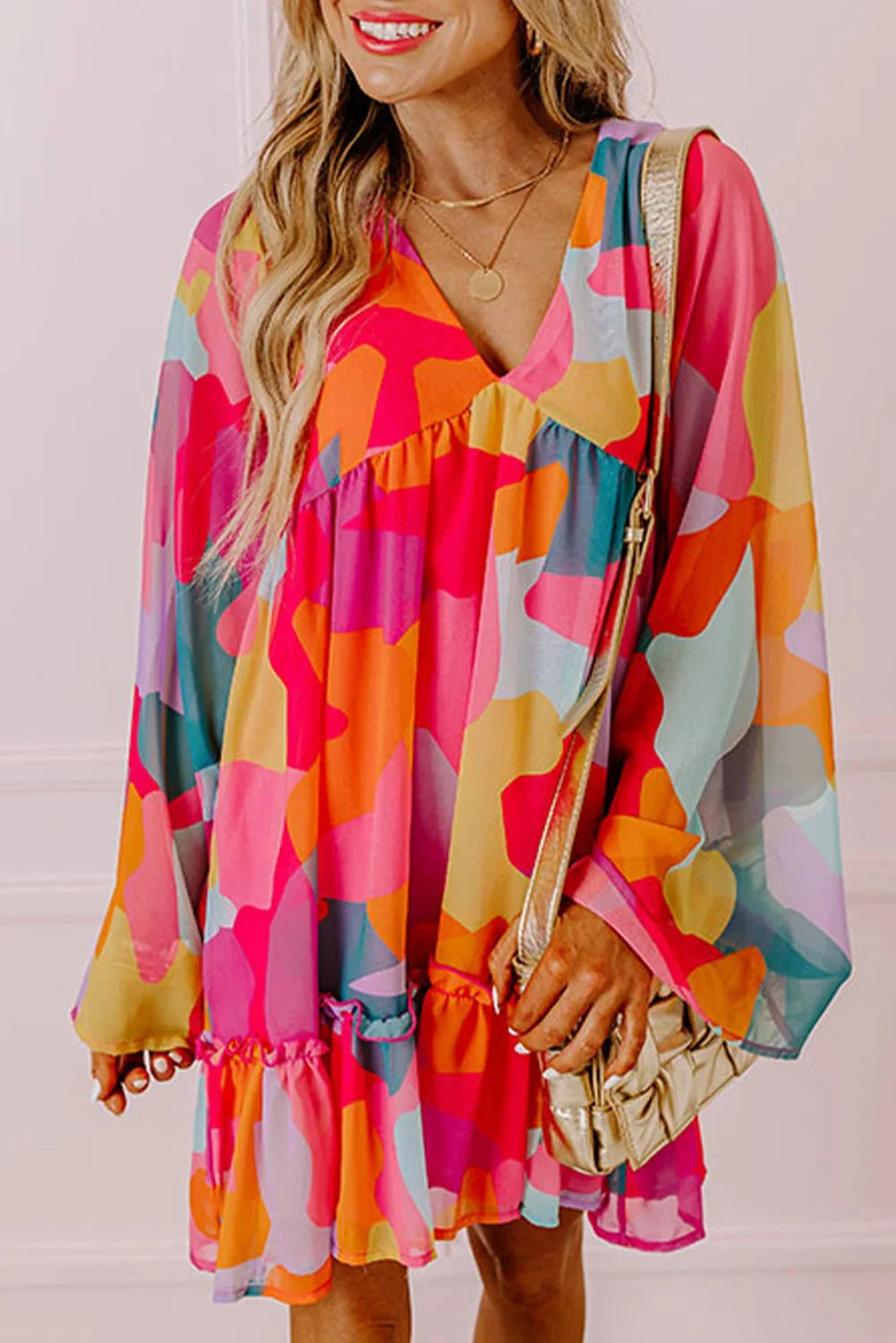 Colorful printed V-neck babydoll dress by Karson, made of soft and flowy fabric, perfect for a casual chic look.