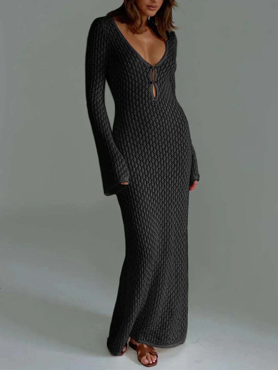 Black fitted crochet dress with elegant neckline, showcasing intricate crochet details and flattering silhouette.