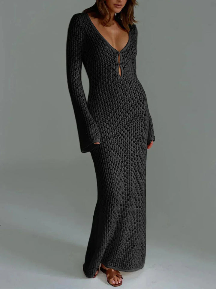 Black fitted crochet dress with elegant neckline, showcasing intricate crochet details and flattering silhouette.