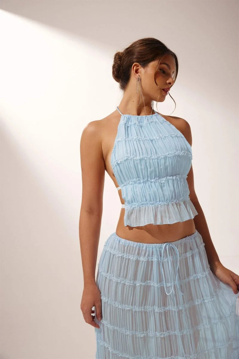 Light blue pleated halter crop top and skirt set made from breathable cotton blend. Perfect for a summer day out.