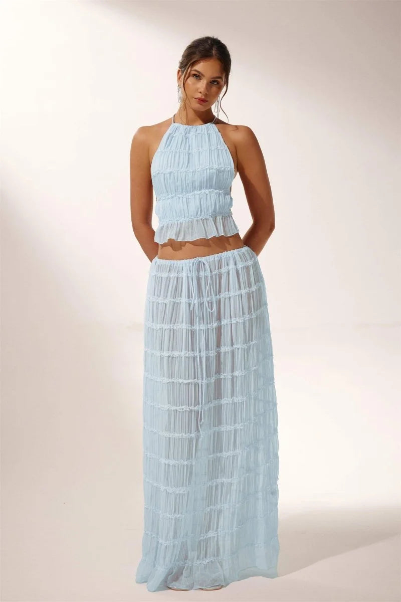 "Light blue pleated halter crop top and skirt set for the Katy collection, featuring a breezy and stylish design."