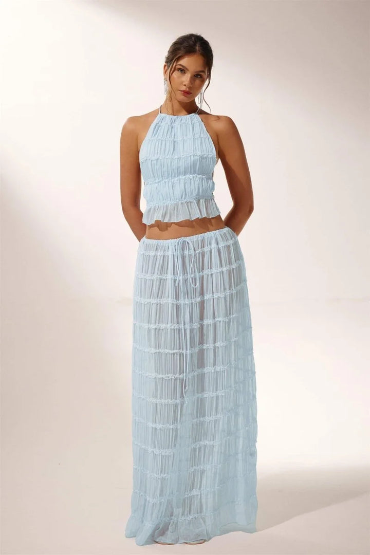 "Light blue pleated halter crop top and skirt set for the Katy collection, featuring a breezy and stylish design."