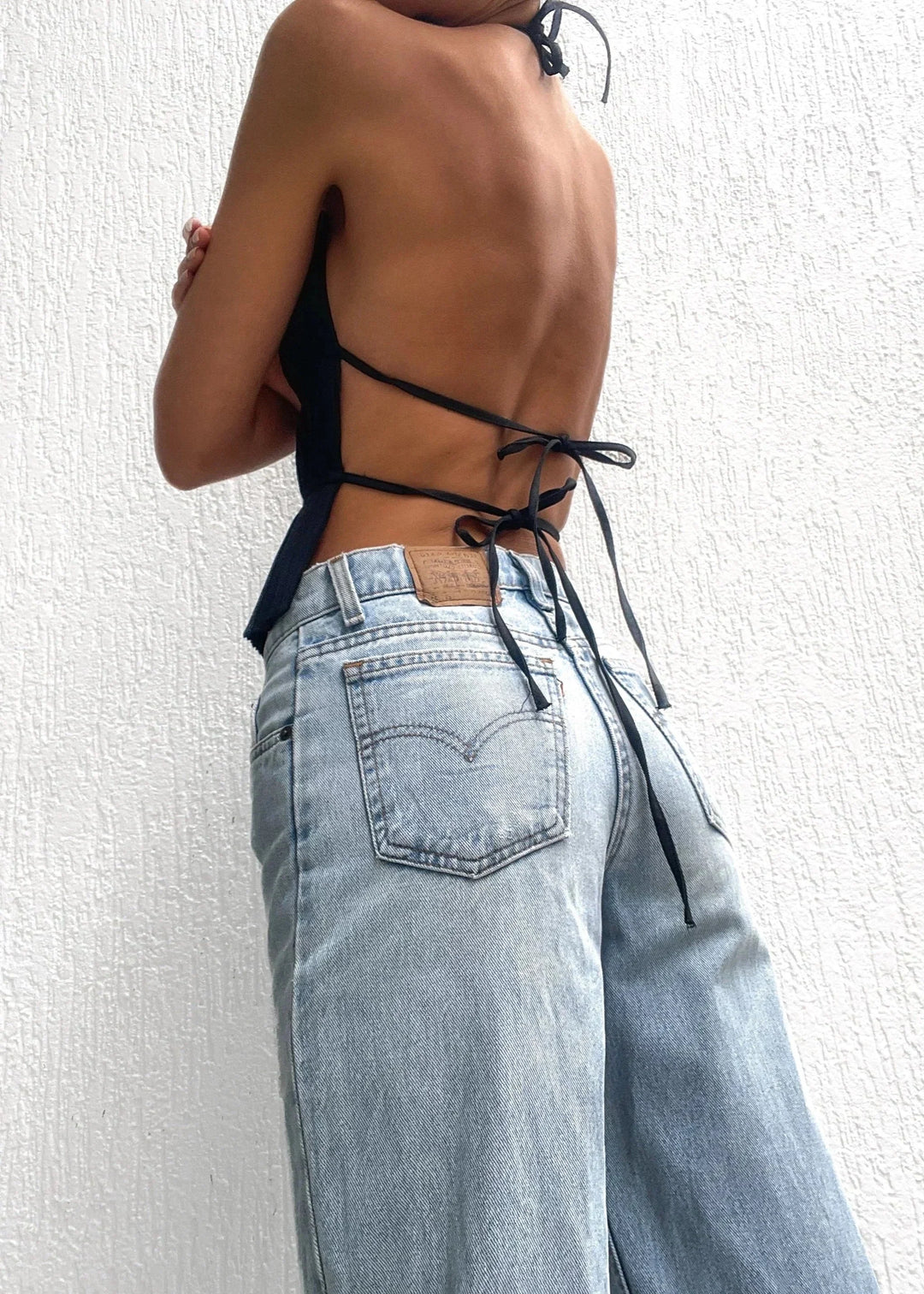 Black halter top showcasing metallic chain detailing and a stylish design by Avi for women.