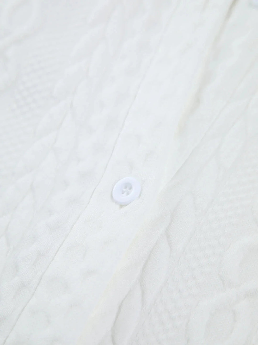 White blouse with textured fabric and sculpted sleeves, perfect for a stylish and sophisticated look.