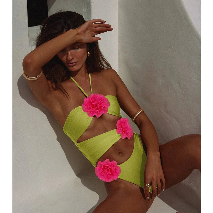 Green two-piece swimsuit with floral applique detailing. Made of high-quality, stretchy fabric for a comfortable and stylish…