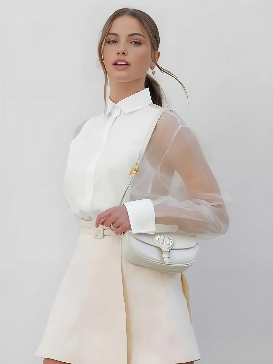 Sheer long sleeves collared mini dress in white with intricate lace detailing and a flattering silhouette by Evie.