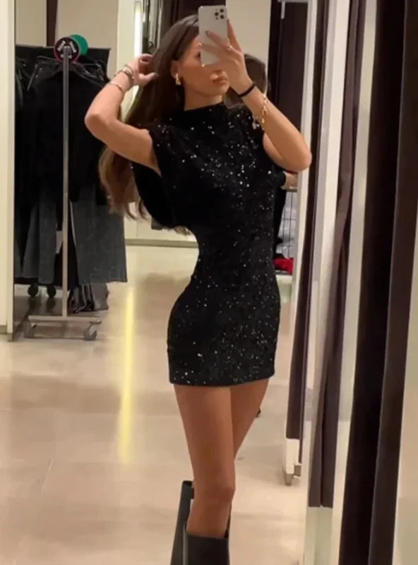 "Stormy sparkly fitted dress with shoulder pads, perfect for a night out, made with premium shimmer fabric."
