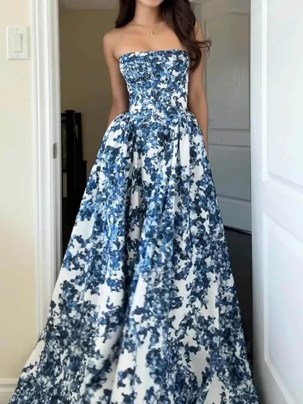 Blue floral printed maxi dress with a strapless design, perfect for warm days. Made from lightweight and flowy material for…