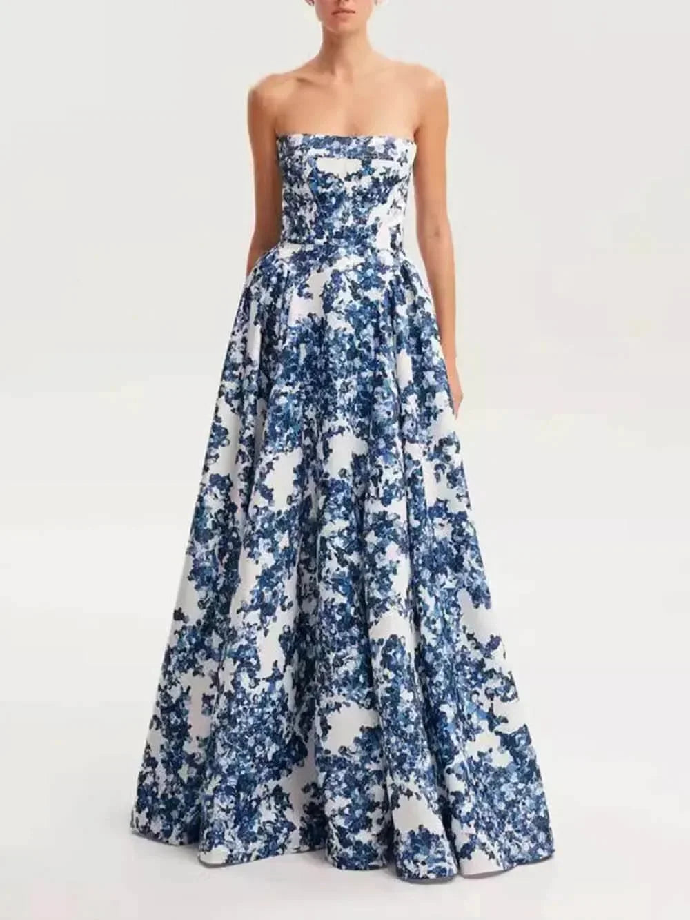 Blue floral printed maxi dress with a strapless design. Made with lightweight and flowy fabric, perfect for a casual yet…