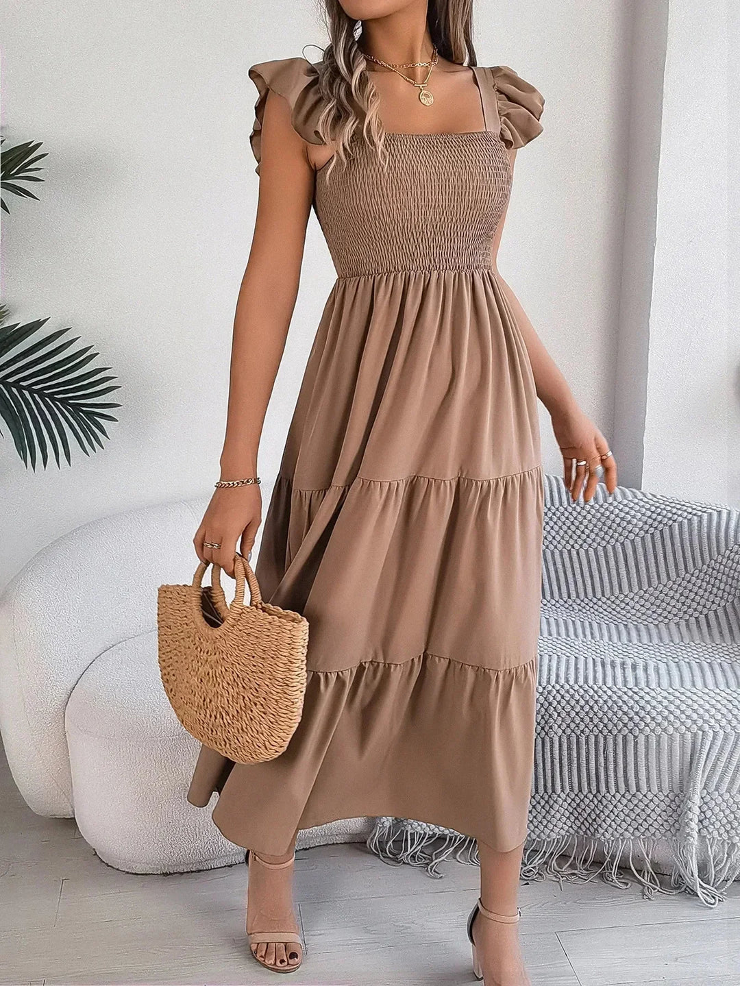 "Tiered ruffle smocked midi dress with a flowy silhouette and soft, breathable fabric in a stylish design by Silvia."
