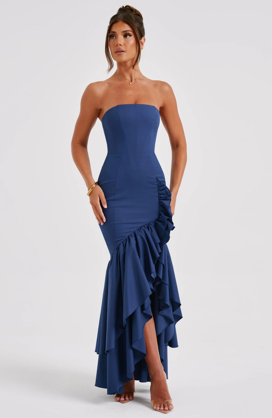 Strapless dress in Adelynne green with ruffle skirt cascading from waist to knee. Made of lightweight, flowy fabric.