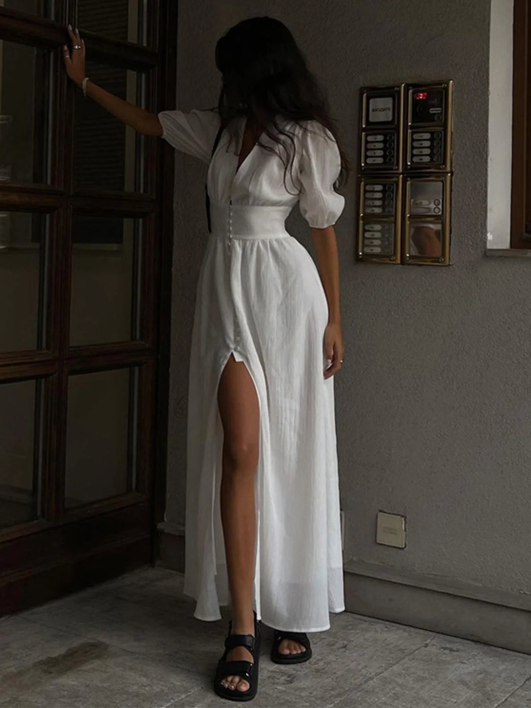 "Ilani shirt dress made of lightweight cotton blend with fitted waist, front slit, and button-up design for a casual, chic…
