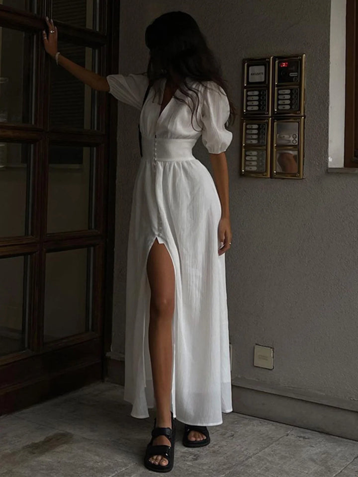 "Ilani shirt dress made of lightweight cotton blend with fitted waist, front slit, and button-up design for a casual, chic…