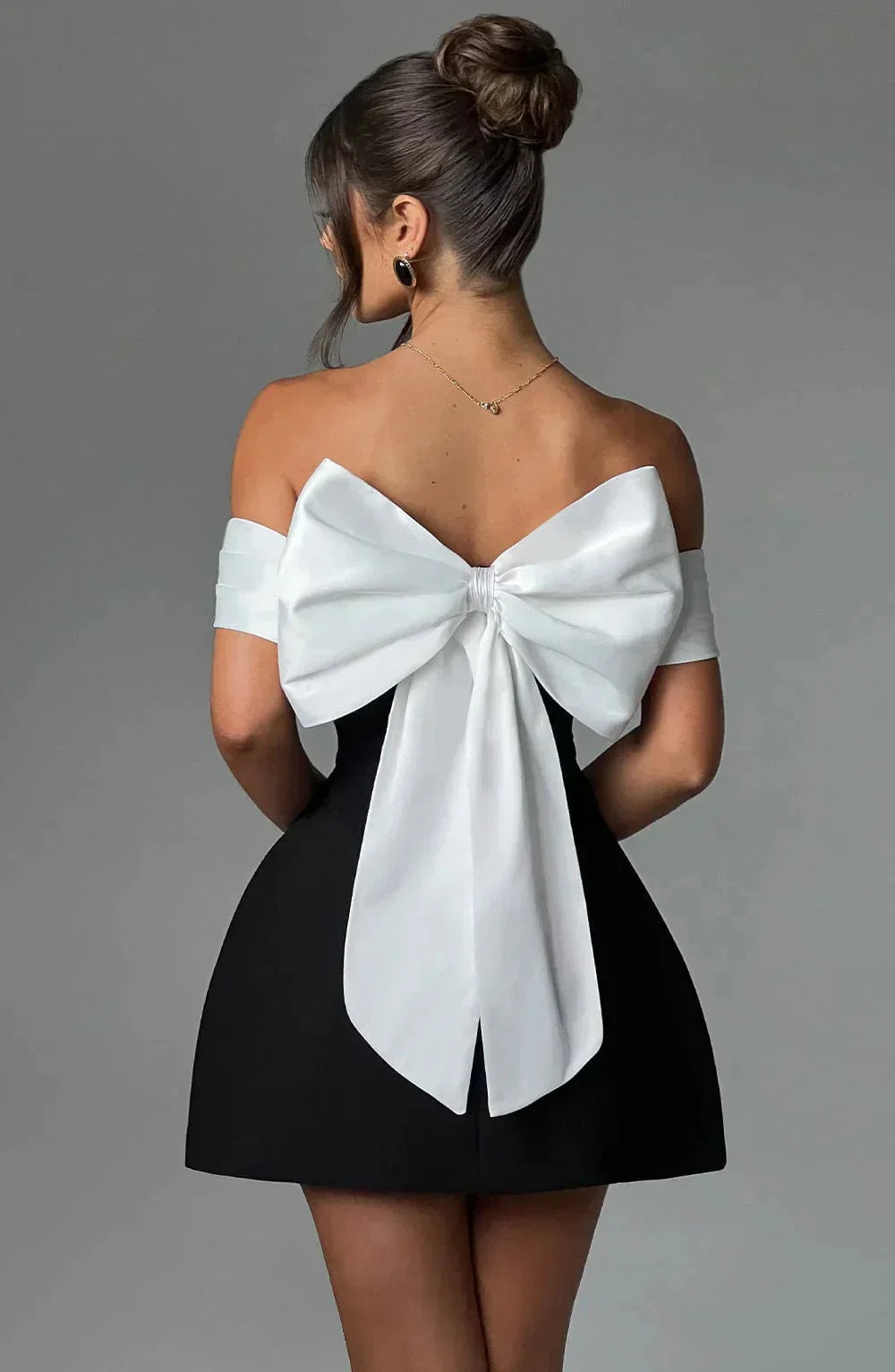 Off-shoulder mini dress in two-tone design with a flowing silhouette and elasticized neckline by Delila.