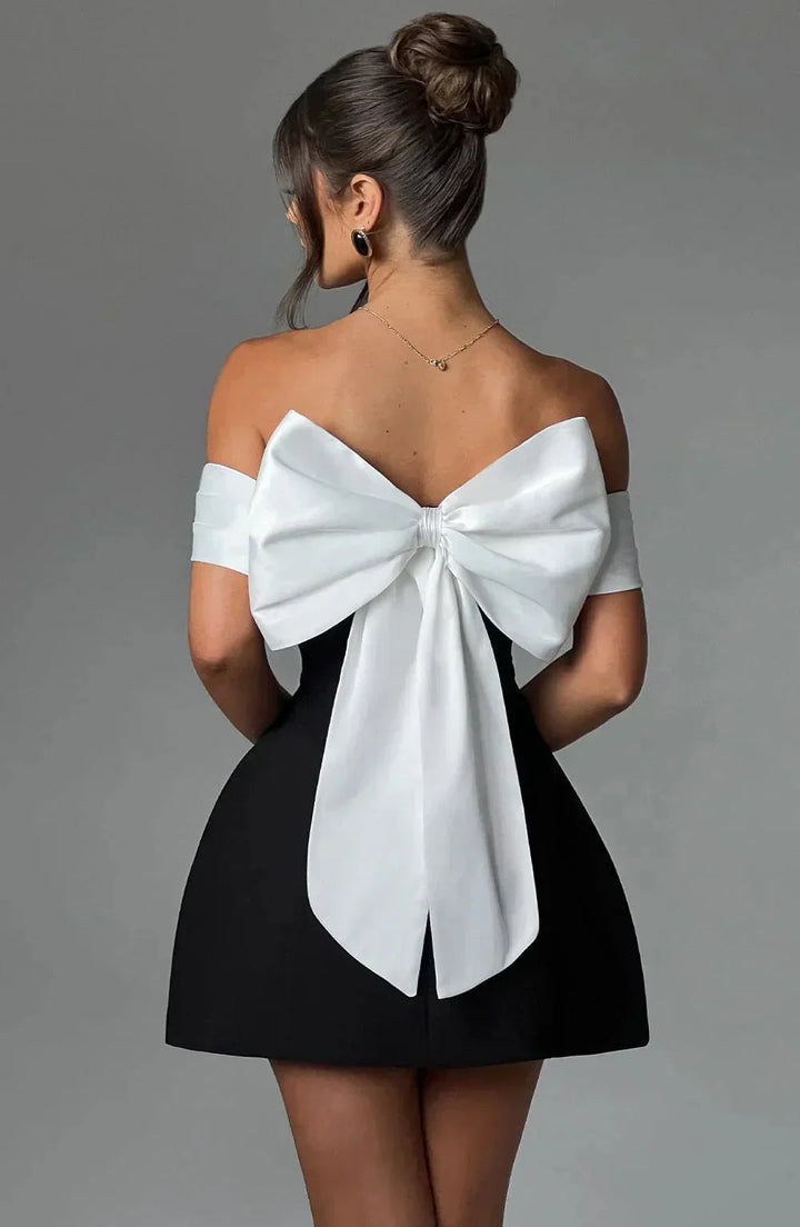 Off-shoulder mini dress in two-tone design with a flowing silhouette and elasticized neckline by Delila.