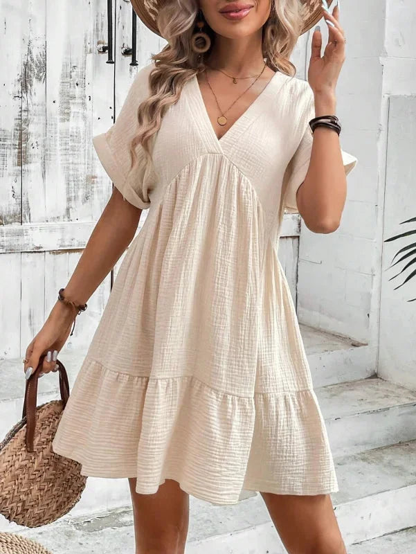 Flowy v-neck dress with ruffled layers, ideal for a whimsical look. Made from lightweight fabric perfect for a casual or…